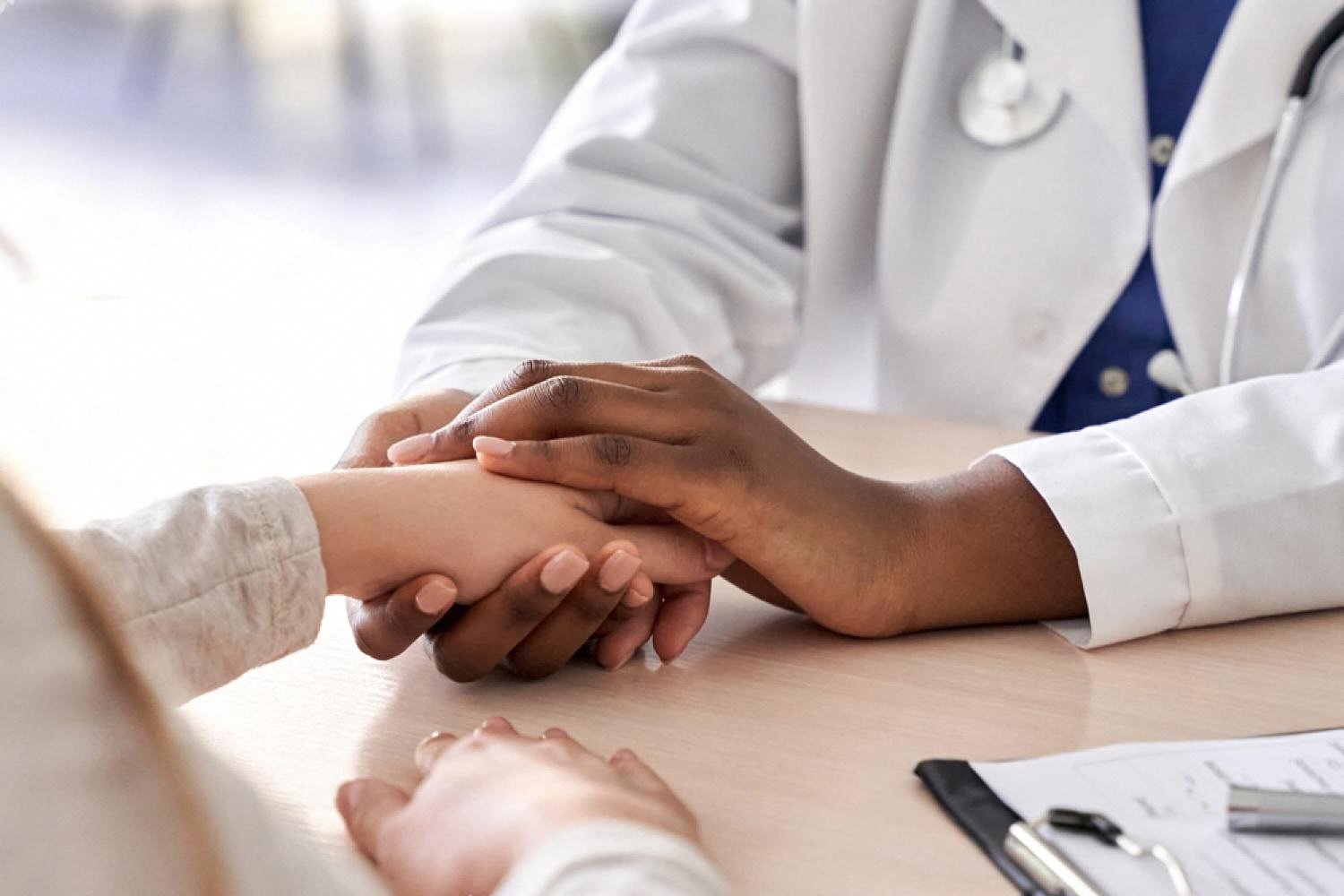 Doctor reassuring a patient during a follow-up consultation after bowel surgery
