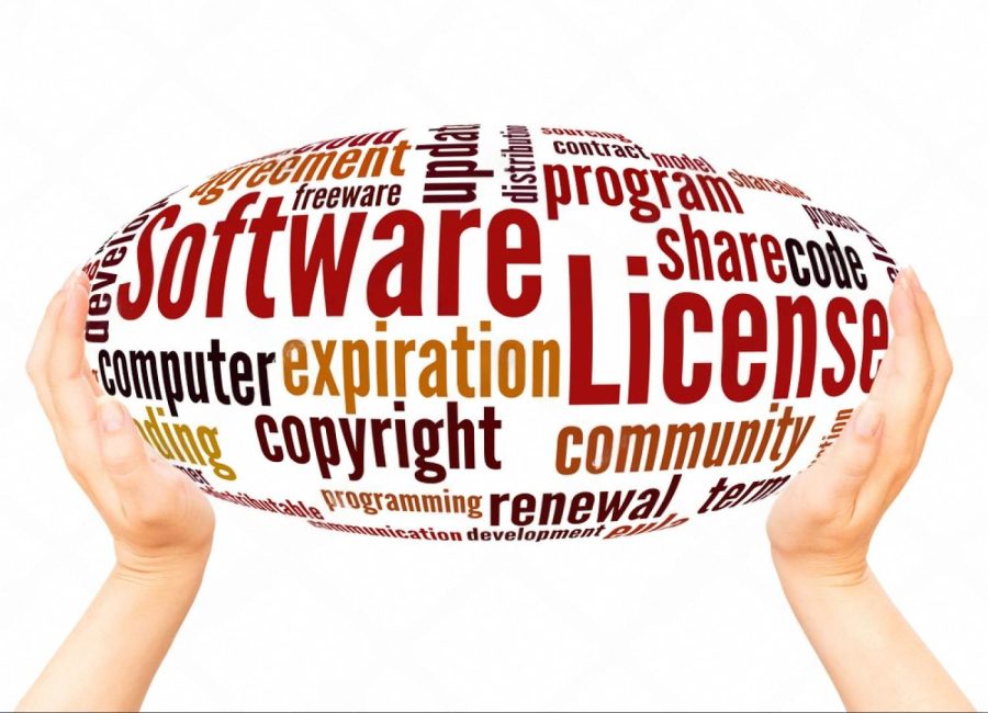Word cloud of software licensing terms held between two hands, illustrating license concepts for UAE businesses